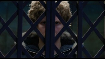 Movie still from “Scott Pilgrim vs. the World” (2010), directed by Edgar Wright – A man with a fur hat is looking through a fence; Close Up shot, Over the shoulder angle
