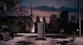 Movie still from “Scott Pilgrim vs. the World” (2010), directed by Edgar Wright – A white door in a city at night; Extreme Wide shot, High angle