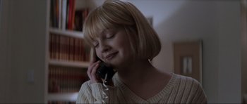Movie still from “Scream” (1996), directed by Wes Craven – A woman talking on a phone while wearing a sweater; Close Up shot, Low angle