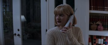 Movie still from “Scream” (1996), directed by Wes Craven – A woman holding a phone up to her ear; Close Up shot, Low angle