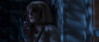 Movie still from “Scream” (1996), directed by Wes Craven – A woman with blonde hair is crying in a dark room; Close Up shot, Low angle