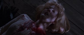 Movie still from “Scream” (1996), directed by Wes Craven – A woman is laying on the ground with blood on her face; Close Up shot, Overhead angle