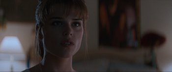 Movie still from “Scream” (1996), directed by Wes Craven – A woman's face in a dark room; Close Up shot, Over the shoulder angle