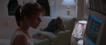 Movie still from “Scream” (1996), directed by Wes Craven – A woman looking at a teddy bear in a living room; Close Up shot, Low angle