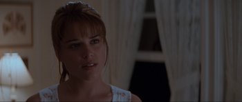 Movie still from “Scream” (1996), directed by Wes Craven – A person wearing a white shirt; Close Up shot, Over the shoulder angle