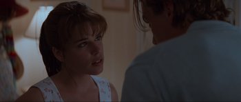 Movie still from “Scream” (1996), directed by Wes Craven – A woman looking at another woman in a room; Close Up shot, Over the shoulder angle