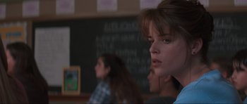 Movie still from “Scream” (1996), directed by Wes Craven – A group of people sitting in front of chalkboards; Close Up shot, Over the shoulder angle