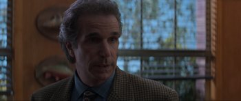 Movie still from “Scream” (1996), directed by Wes Craven – A person wearing a suit and tie; Close Up shot, Over the shoulder angle