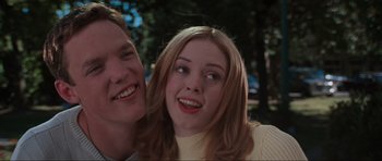 Movie still from “Scream” (1996), directed by Wes Craven – A man and a woman smiling for the camera; Close Up shot, Low angle