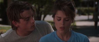 Movie still from “Scream” (1996), directed by Wes Craven – A man and a woman sitting next to each other; Close Up shot, Over the shoulder angle