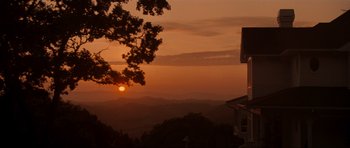 Movie still from “Scream” (1996), directed by Wes Craven – The sun is setting over a mountain range; Extreme Wide shot, Low angle