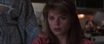 Movie still from “Scream” (1996), directed by Wes Craven – A person with long brown hair; Close Up shot, Over the shoulder angle