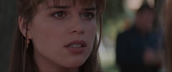 Movie still from “Scream” (1996), directed by Wes Craven – A woman's face in a forest; Close Up shot, Over the shoulder angle