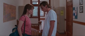 Movie still from “Scream” (1996), directed by Wes Craven – A man and a woman looking at a cell phone; Medium shot, Low angle