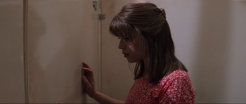 Movie still from “Scream” (1996), directed by Wes Craven – A woman in a red dress looking at a wall; Close Up shot, Over the shoulder angle