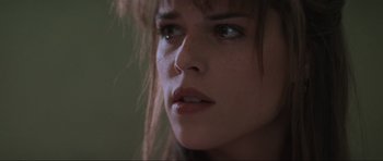 Movie still from “Scream” (1996), directed by Wes Craven – A woman's face in a dark room; Close Up shot, Low angle