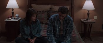 Movie still from “Scream” (1996), directed by Wes Craven – A man and a woman sitting on a bed in front of each other; Medium shot, Over the shoulder angle