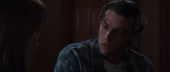 Movie still from “Scream” (1996), directed by Wes Craven – A person sitting in a room; Close Up shot, Over the shoulder angle