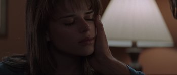 Movie still from “Scream” (1996), directed by Wes Craven – A person touching the face of another person; Extreme Close Up shot, Over the shoulder angle