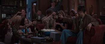 Movie still from “Scream” (1996), directed by Wes Craven – A group of people sitting around a table with drinks; Wide shot, High angle