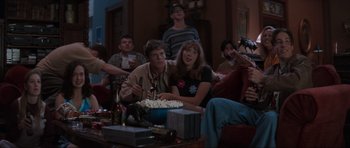 Movie still from “Scream” (1996), directed by Wes Craven – A group of people sitting around a table; Wide shot, High angle