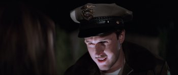 Movie still from “Scream” (1996), directed by Wes Craven – A person wearing a hat; Close Up shot, Low angle