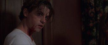 Movie still from “Scream” (1996), directed by Wes Craven – A young man with blood all over his face; Close Up shot, Low angle