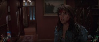 Movie still from “Scream” (1996), directed by Wes Craven – A young woman with blood all over her face; Medium shot, Over the shoulder angle