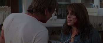 Movie still from “Scream” (1996), directed by Wes Craven – A man and a woman talking in a kitchen; Close Up shot, Over the shoulder angle