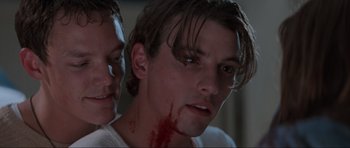 Movie still from “Scream” (1996), directed by Wes Craven – A man with blood all over his face and neck; Close Up shot, Low angle