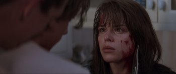 Movie still from “Scream” (1996), directed by Wes Craven – A young woman with blood all over her face; Close Up shot, Over the shoulder angle