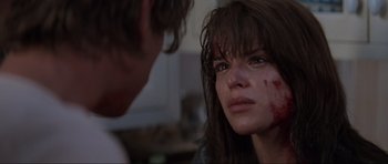 Movie still from “Scream” (1996), directed by Wes Craven – A man and a woman looking at each other with blood on their face; Close Up shot, Over the shoulder angle
