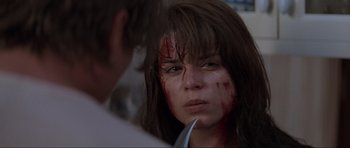 Movie still from “Scream” (1996), directed by Wes Craven – A woman with blood all over her face; Close Up shot, Over the shoulder angle