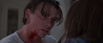 Movie still from “Scream” (1996), directed by Wes Craven – A man with blood all over his face; Close Up shot, Over the shoulder angle