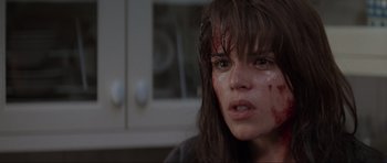 Movie still from “Scream” (1996), directed by Wes Craven – A woman with blood all over her face; Close Up shot, Over the shoulder angle