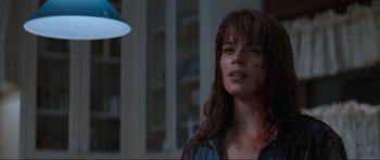Movie still from “Scream” (1996), directed by Wes Craven – A young woman with blood all over her face; Close Up shot, Over the shoulder angle