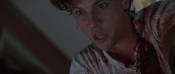 Movie still from “Scream” (1996), directed by Wes Craven – A person with blood all over his face; Close Up shot, Low angle