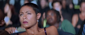 Movie still from “Scream 2” (1997), directed by Wes Craven – A person with a crowd in the background; Close Up shot, Low angle