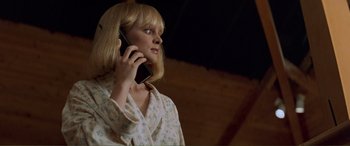 Movie still from “Scream 2” (1997), directed by Wes Craven – A woman in a white robe talking on a cell phone; Medium shot, Low angle