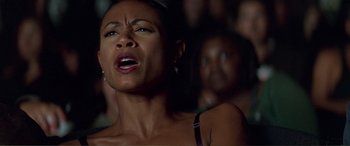 Movie still from “Scream 2” (1997), directed by Wes Craven – A person singing in front of a crowd; Close Up shot, Low angle