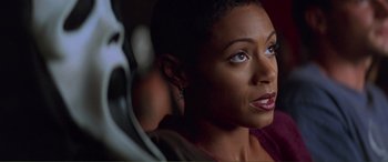 Movie still from “Scream 2” (1997), directed by Wes Craven – A person with short black hair; Close Up shot, Over the shoulder angle