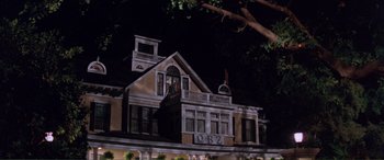 Movie still from “Scream 2” (1997), directed by Wes Craven – A man standing on the top of a building at night; Wide shot, Low angle