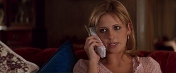 Movie still from “Scream 2” (1997), directed by Wes Craven – A woman holding a cell phone to her ear; Close Up shot, High angle