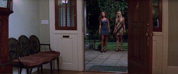 Movie still from “Scream 2” (1997), directed by Wes Craven – Two women standing in front of an open front door; Wide shot, Low angle