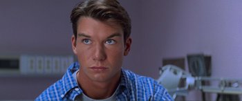 Movie still from “Scream 2” (1997), directed by Wes Craven – A person wearing a blue shirt; Close Up shot, Over the shoulder angle