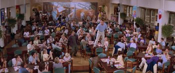 Movie still from “Scream 2” (1997), directed by Wes Craven – A large group of people sitting at tables in a restaurant; Wide shot, High angle