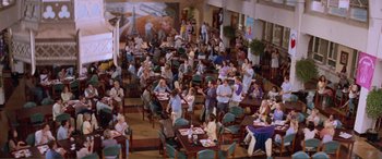 Movie still from “Scream 2” (1997), directed by Wes Craven – A large group of people sitting at tables in a restaurant; Extreme Wide shot, High angle