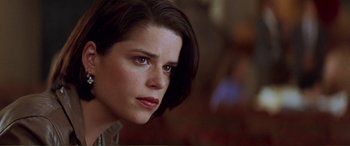 Movie still from “Scream 2” (1997), directed by Wes Craven – A person with short black hair; Close Up shot, Over the shoulder angle