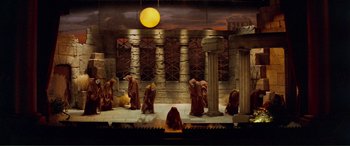 Movie still from “Scream 2” (1997), directed by Wes Craven – A group of people standing in front of a stone wall; Extreme Wide shot, High angle