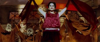 Movie still from “Scream 2” (1997), directed by Wes Craven – A woman standing in front of a group of people; Medium shot, Low angle